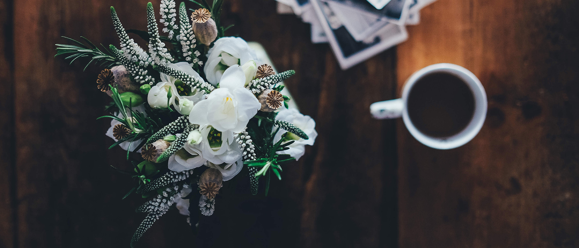 casestudy-01.jpg Table with flowers and a cup of coffee